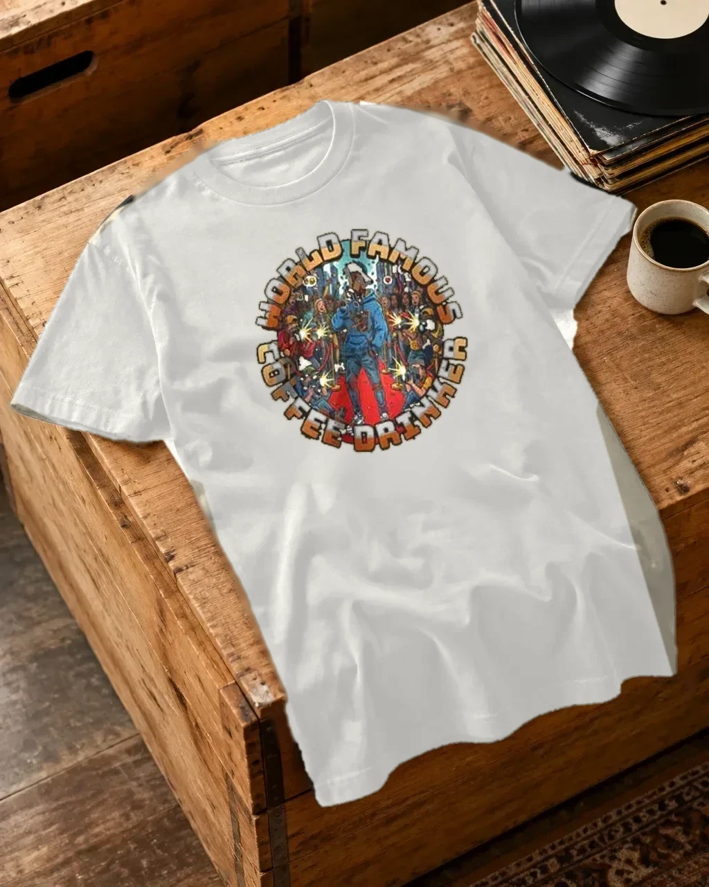 Folded graphic tees with coffee nearby